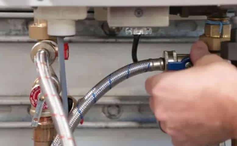 Person Fixing a Tankless Water Heater.