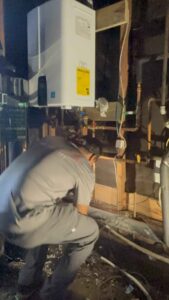 Technician working on tankless water heater