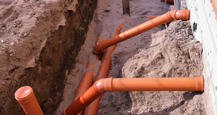 Orange pipes in the ground, properly installed.