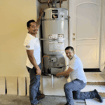 Tankless Guys plumbers next to their past repair projects.